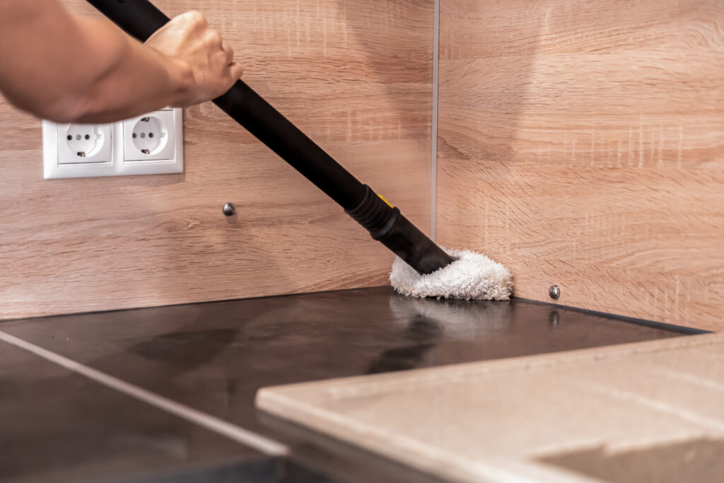 Kitchen cleaning with a steam cleaner, care for cleanliness and biologically clean treatment for removing dirt, care for the health and cleanliness of the kitchen and living spaces