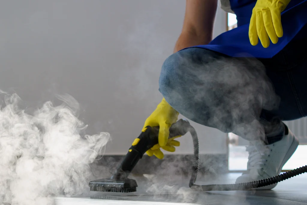 Professional steam cleaning service using a steam cleaner on a floor